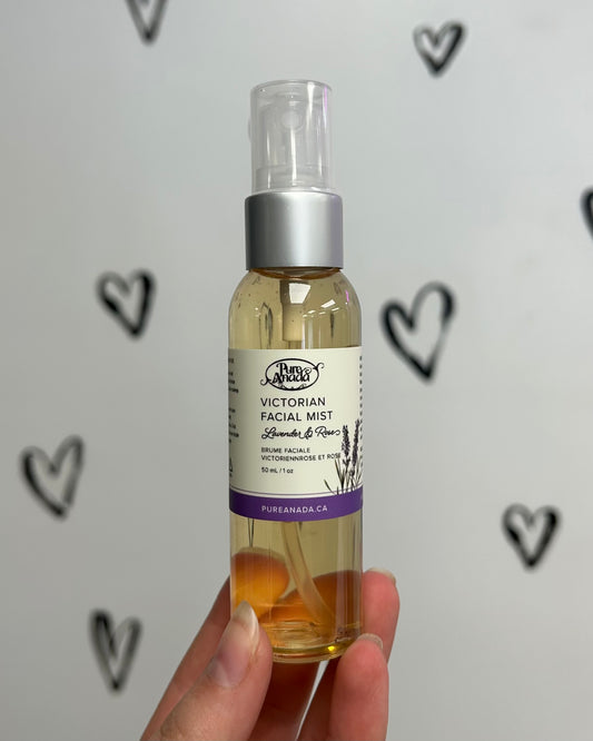 Hand holding a bottle of 'Victorian Facial Mist' with a heart pattern in the background